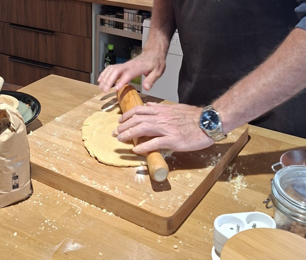 Burgundy cooking experience Burgundy cooking experience. you can see a man using a rolling pin to roll out dough on a wooden board